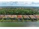 Beautiful waterfront homes boast screened-in lanais and private pools, surrounded by lush landscaping and serene lake views at 344 Maraviya Blvd, Nokomis, FL 34275