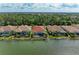 Scenic view of waterfront homes featuring screened lanais and lush landscaping, offering a private retreat with lake access at 344 Maraviya Blvd, Nokomis, FL 34275