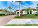 Charming home with a paver driveway, beautiful landscaping, and a welcoming entrance at 344 Maraviya Blvd, Nokomis, FL 34275
