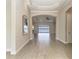 Spacious hallway with tile flooring, archways, and a view of the outdoor area by the water at 344 Maraviya Blvd, Nokomis, FL 34275