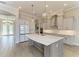 Open kitchen concept with an oversized island, stainless steel appliances, and modern cabinetry at 344 Maraviya Blvd, Nokomis, FL 34275