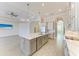 Bright kitchen boasts a large island with quartz countertops, stainless appliances, and designer fixtures at 344 Maraviya Blvd, Nokomis, FL 34275