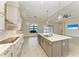 Open kitchen features a large island, sleek appliances, and modern finishes, perfect for entertaining at 344 Maraviya Blvd, Nokomis, FL 34275