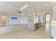 A spacious kitchen features an island, stainless steel appliances, and modern lighting fixtures at 344 Maraviya Blvd, Nokomis, FL 34275