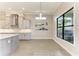 Bright kitchen features white cabinetry, sleek appliances, and an adjacent dining area with large windows at 344 Maraviya Blvd, Nokomis, FL 34275