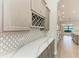 Elegant kitchenette features a wine rack, granite countertops, and views of the backyard through the windows at 344 Maraviya Blvd, Nokomis, FL 34275