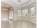 Open living area with wood-look tile flooring, decorative windows, and an elegant crystal chandelier at 344 Maraviya Blvd, Nokomis, FL 34275