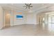 Spacious living room with tile floors, ceiling fan, and television, enhanced by elegant archways and ample natural light at 344 Maraviya Blvd, Nokomis, FL 34275
