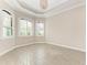 Bright living area with three windows and plantation shutters, tile flooring, and soft neutral wall color at 344 Maraviya Blvd, Nokomis, FL 34275
