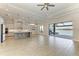 Open-concept living area with tile floors, island kitchen, and sliding doors to the outdoor pool and water view at 344 Maraviya Blvd, Nokomis, FL 34275