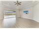 Bright, open living room with tile floors, ceiling fan, and a sliding door offering water views at 344 Maraviya Blvd, Nokomis, FL 34275