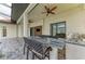 Covered outdoor kitchen has counter seating and backyard access to enjoy outdoor entertainment at 344 Maraviya Blvd, Nokomis, FL 34275