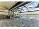 Covered patio featuring outdoor kitchen, bar seating, and a screened-in pool with scenic lake views at 344 Maraviya Blvd, Nokomis, FL 34275