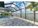 Beautiful screened-in pool and spa with brick-paved patio and stunning water views, surrounded by palm trees at 344 Maraviya Blvd, Nokomis, FL 34275