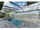 Gorgeous screened pool and spa overlook lake views from outdoor living space with lush landscaping at 344 Maraviya Blvd, Nokomis, FL 34275