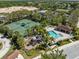 Aerial view of community amenities including a pool, tennis courts, a playground, and beautiful landscaping at 3736 82Nd Avenue E Cir # 104, Sarasota, FL 34243
