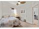 A well-lit bedroom with neutral tones showcasing Eiffel Tower themed decor, and a charming window with a curtain at 3736 82Nd Avenue E Cir # 104, Sarasota, FL 34243
