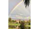 Charming community view with landscaped lawns, ponds and a rainbow arched across the sky at 3736 82Nd Avenue E Cir # 104, Sarasota, FL 34243
