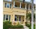 Inviting two-story home with lush landscaping, a covered entry, and charming architectural details at 3736 82Nd Avenue E Cir # 104, Sarasota, FL 34243