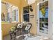 Inviting front porch with stylish seating, a decorative wreath, and a well-lit entry at 3736 82Nd Avenue E Cir # 104, Sarasota, FL 34243