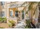 Charming front porch with seating, a decorative wreath, and a well-maintained garden at 3736 82Nd Avenue E Cir # 104, Sarasota, FL 34243