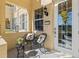 Inviting front porch with stylish seating, a decorative wreath, and a well-lit entry at 3736 82Nd Avenue E Cir # 104, Sarasota, FL 34243