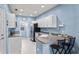 A kitchen featuring white cabinets, stainless steel appliances, and a breakfast bar at 3736 82Nd Avenue E Cir # 104, Sarasota, FL 34243