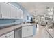 Open concept kitchen with stainless steel appliances and breakfast bar, leading to living area at 3736 82Nd Avenue E Cir # 104, Sarasota, FL 34243
