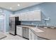 Well-lit kitchen with stainless steel appliances and ample counter space at 3736 82Nd Avenue E Cir # 104, Sarasota, FL 34243