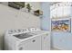 Laundry room with front load washer and dryer and decorative window at 3736 82Nd Avenue E Cir # 104, Sarasota, FL 34243