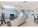 Bright living room with tile floors, ceiling fan, and staircase access at 3736 82Nd Avenue E Cir # 104, Sarasota, FL 34243