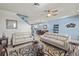 Cozy living room with neutral tones, a ceiling fan, and an open view to the dining area at 3736 82Nd Avenue E Cir # 104, Sarasota, FL 34243