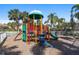 Community playground featuring slides, stairs, and other structures with lush green landscape and plenty of sunshine at 3736 82Nd Avenue E Cir # 104, Sarasota, FL 34243