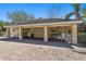 Community pool pavilion featuring a tile roof, ceiling fans, and outdoor seating by a brick-paved pool at 3736 82Nd Avenue E Cir # 104, Sarasota, FL 34243