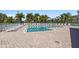 Community pool surrounded by palm trees and lounge chairs, creating a serene and inviting atmosphere at 3736 82Nd Avenue E Cir # 104, Sarasota, FL 34243