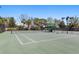 Well-maintained community tennis court with professional lighting, shaded benches, and lush landscaping around perimeter at 3736 82Nd Avenue E Cir # 104, Sarasota, FL 34243