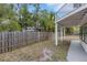 Exterior view of the backyard featuring a covered patio and wood privacy fence at 3857 Woodrow Ridge St, Sarasota, FL 34233