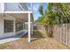 Exterior view of the backyard featuring a covered patio and wood privacy fence at 3857 Woodrow Ridge St, Sarasota, FL 34233