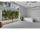 Bright bedroom featuring walk out balcony and wall mounted AC unit at 3857 Woodrow Ridge St, Sarasota, FL 34233