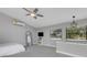 Bright bedroom featuring large windows, wall mounted AC unit and modern light fixture at 3857 Woodrow Ridge St, Sarasota, FL 34233