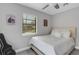 Bedroom featuring bright windows that let in natural light and grey wood-look floors at 3857 Woodrow Ridge St, Sarasota, FL 34233