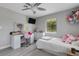 Comfortable bedroom with ceiling fan, vanity, large window and modern gray flooring at 3857 Woodrow Ridge St, Sarasota, FL 34233
