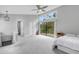 Spacious bedroom with access to private deck, large windows and ensuite bathroom at 3857 Woodrow Ridge St, Sarasota, FL 34233