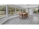 Bright dining area featuring multiple windows and natural light, with modern gray flooring at 3857 Woodrow Ridge St, Sarasota, FL 34233