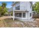 Exterior view of the home featuring a balcony and backyard at 3857 Woodrow Ridge St, Sarasota, FL 34233