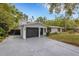 Exterior of home showing a driveway, two-car garage, and lush lawn at 3857 Woodrow Ridge St, Sarasota, FL 34233