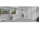 Hallway featuring views into the bathroom and large bright windows at 3857 Woodrow Ridge St, Sarasota, FL 34233