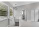 Hallway featuring views into the bathroom and large bright windows at 3857 Woodrow Ridge St, Sarasota, FL 34233