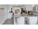Modern kitchen with granite countertops, white cabinets, stainless steel appliances, and a breakfast bar with seating at 3857 Woodrow Ridge St, Sarasota, FL 34233