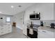 Contemporary kitchen featuring white cabinetry, stainless steel appliances, granite countertops, and an open design at 3857 Woodrow Ridge St, Sarasota, FL 34233
